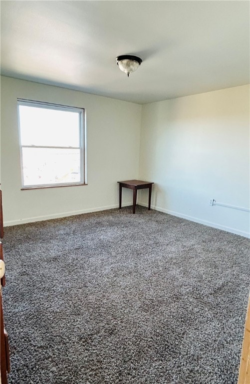 empty room with dark colored carpet