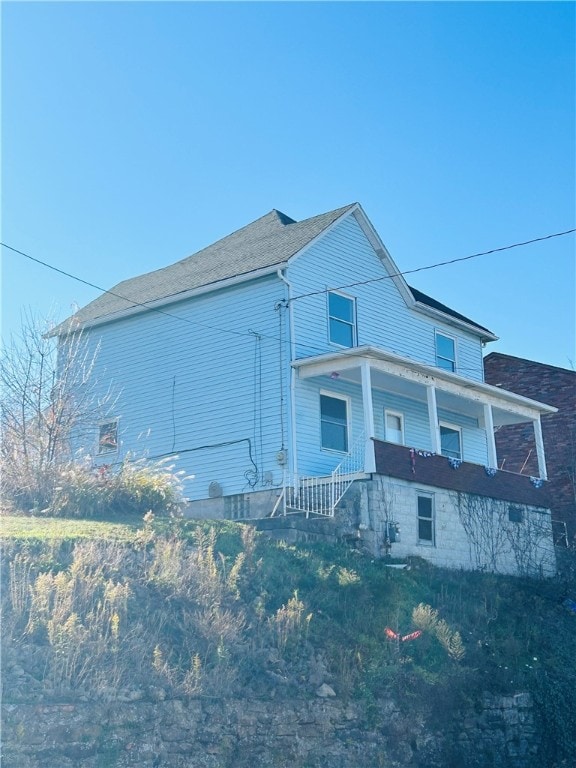 view of side of home with covered porch