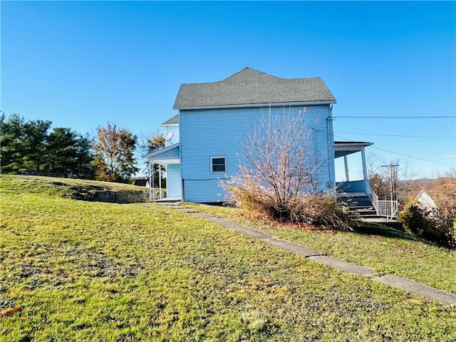 view of side of home with a lawn