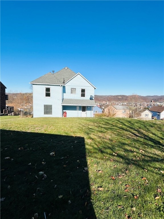 rear view of house with a lawn