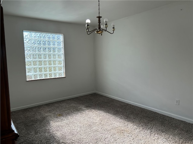 unfurnished room featuring dark carpet and an inviting chandelier