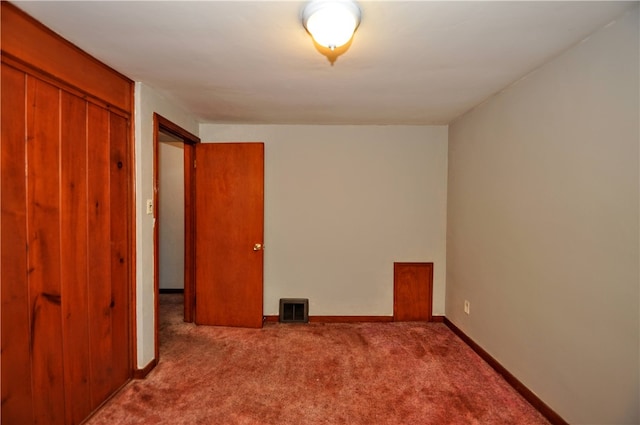 spare room featuring light carpet