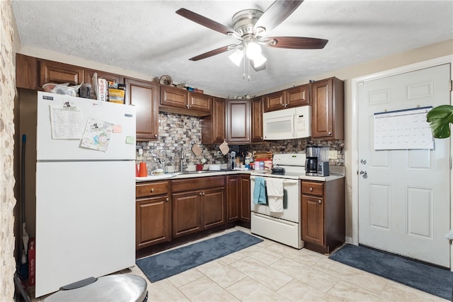 kitchen featuring light tile patterned flooring, ceiling fan, a textured ceiling, white appliances, and decorative backsplash