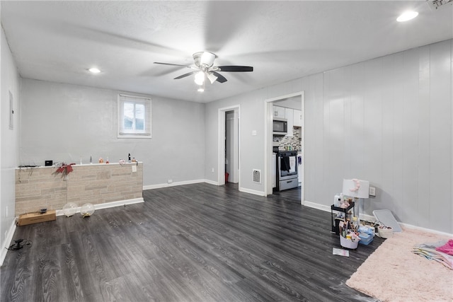 interior space featuring dark wood-type flooring, a textured ceiling, and ceiling fan