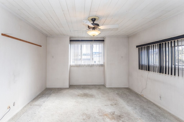carpeted empty room with ceiling fan and wood ceiling