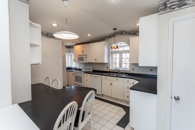 kitchen with hanging light fixtures, white appliances, white cabinetry, and sink