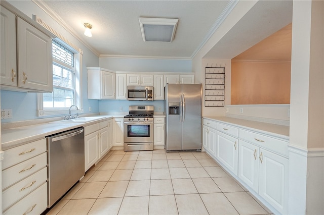 kitchen with white cabinetry, crown molding, and stainless steel appliances