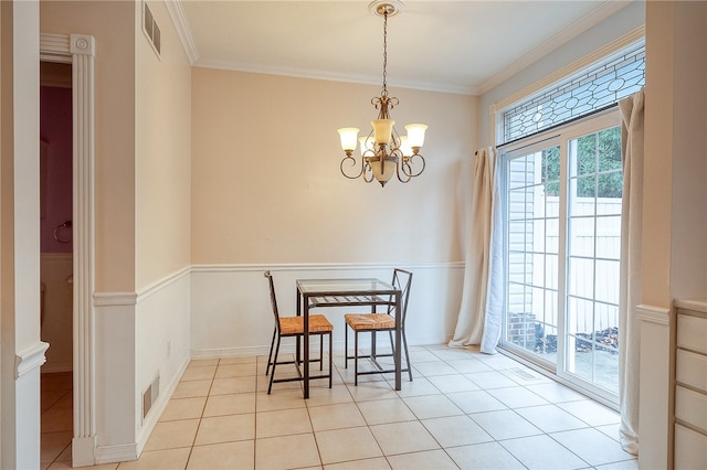 dining room with plenty of natural light, light tile patterned floors, ornamental molding, and an inviting chandelier