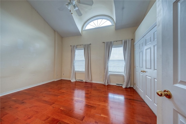 empty room featuring vaulted ceiling, ceiling fan, and hardwood / wood-style flooring