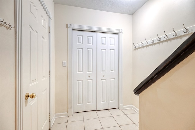 tiled foyer entrance featuring a textured ceiling