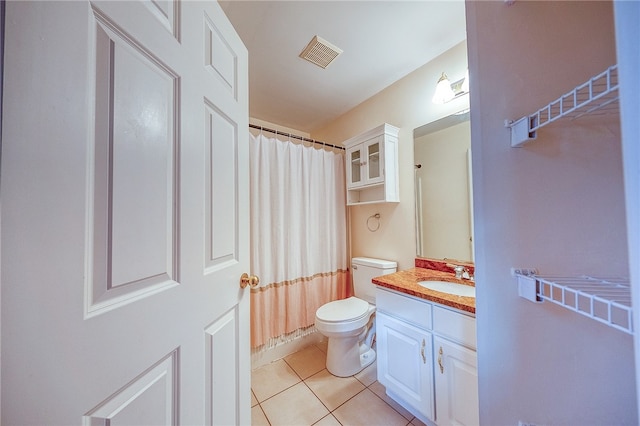 bathroom featuring toilet, vanity, tile patterned floors, and walk in shower