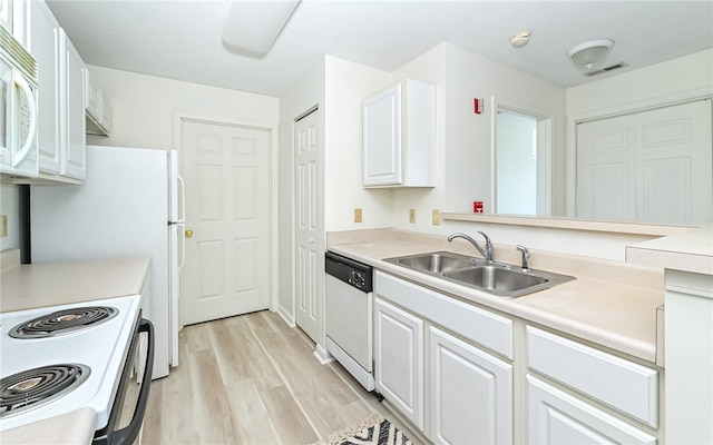 kitchen with white cabinetry, sink, white appliances, and light hardwood / wood-style flooring