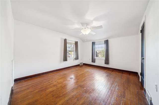 empty room with dark hardwood / wood-style floors and ceiling fan