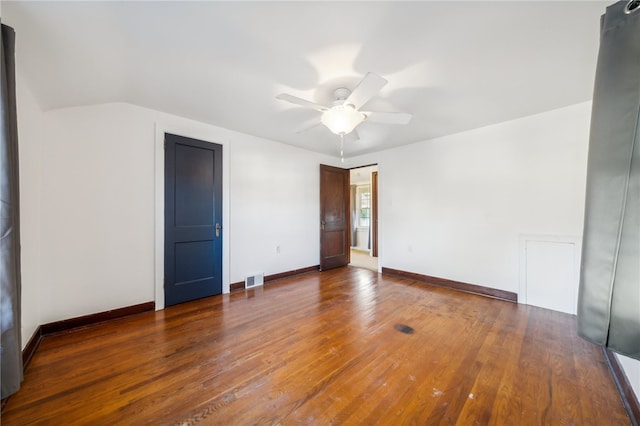 empty room with dark hardwood / wood-style floors and ceiling fan