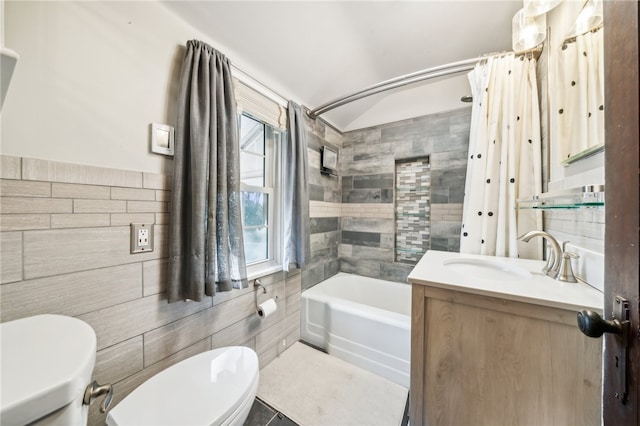 full bathroom with shower / tub combo, tile patterned floors, vanity, tile walls, and toilet