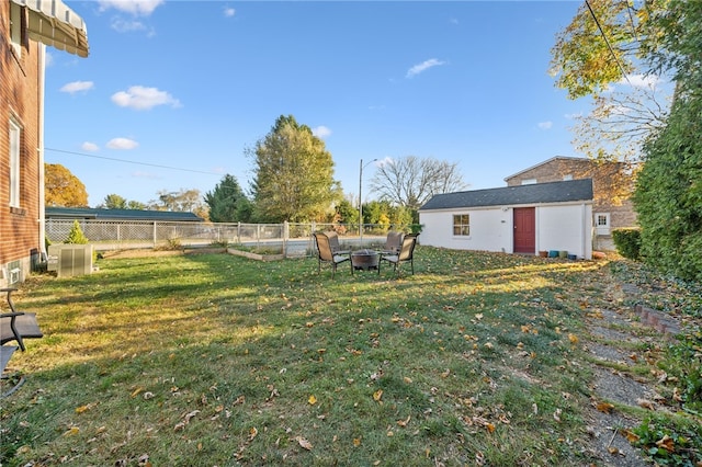 view of yard with an outdoor fire pit and an outdoor structure