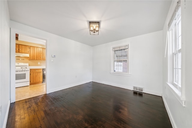 unfurnished room with hardwood / wood-style floors