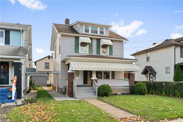 view of property featuring a front lawn and covered porch