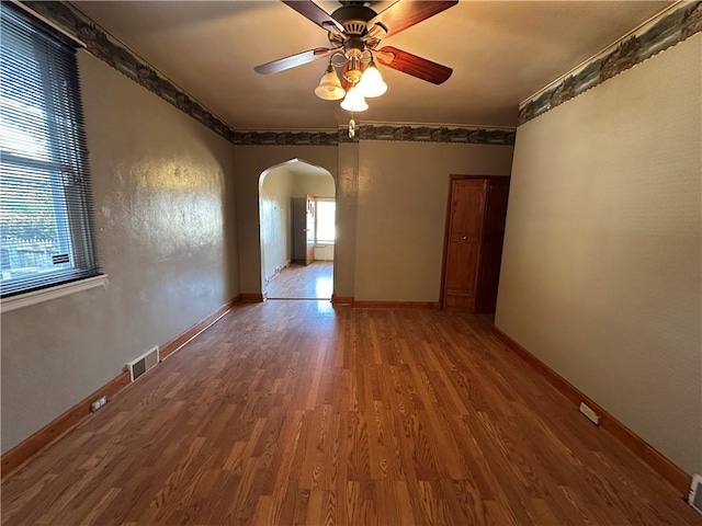1447 Fleming Ave, Mckees Rocks, PA 15136 - spare room with arched walkways, wood finished floors, a ceiling fan, and baseboards