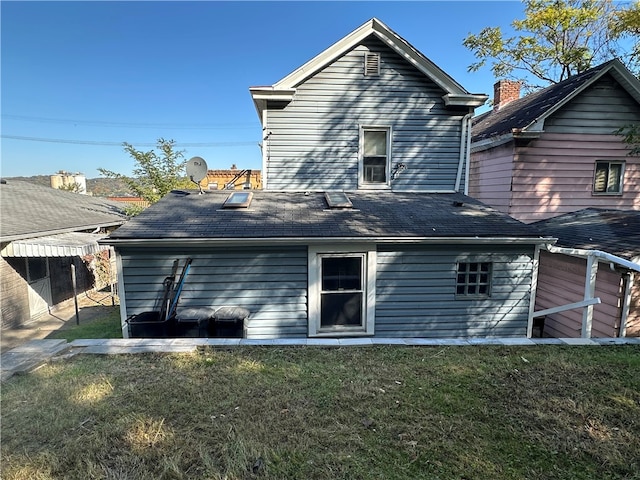 rear view of house with a lawn