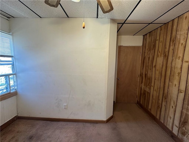 1447 Fleming Ave, Mckees Rocks, PA 15136 - carpeted spare room featuring wooden walls, a paneled ceiling, baseboards, and ceiling fan