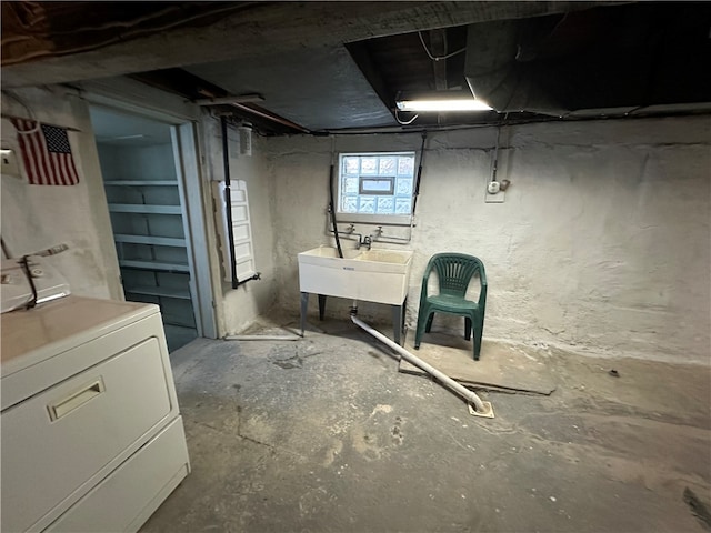 basement featuring washer / dryer and sink