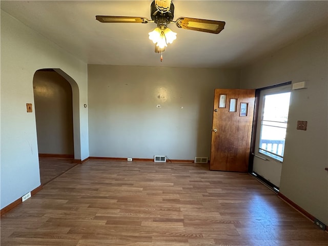 empty room featuring ceiling fan and wood-type flooring