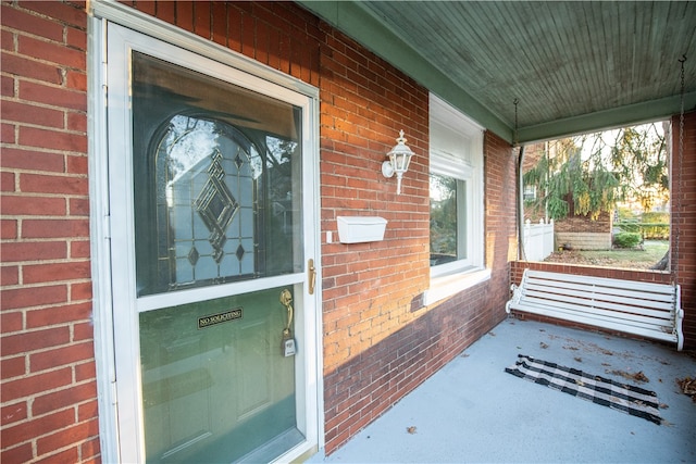 view of exterior entry with covered porch