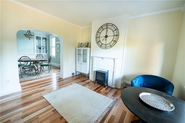 living room with wood-type flooring and ornamental molding