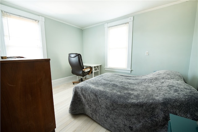 bedroom with crown molding, multiple windows, and light wood-type flooring