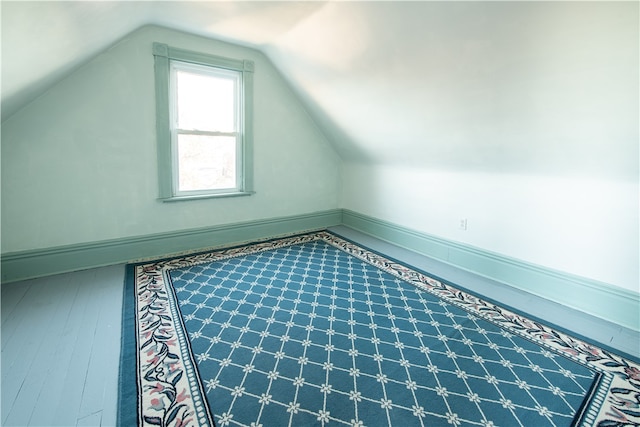 additional living space featuring vaulted ceiling and hardwood / wood-style floors