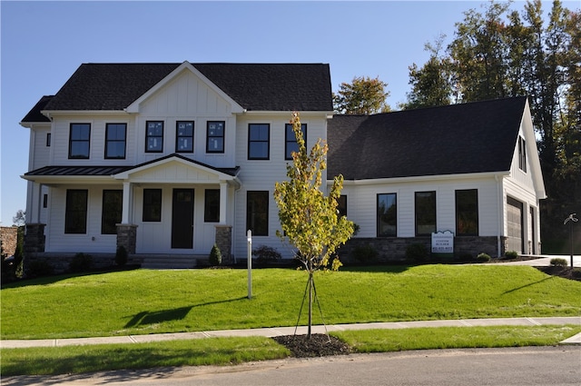 modern farmhouse style home with board and batten siding, a garage, a shingled roof, and a front lawn