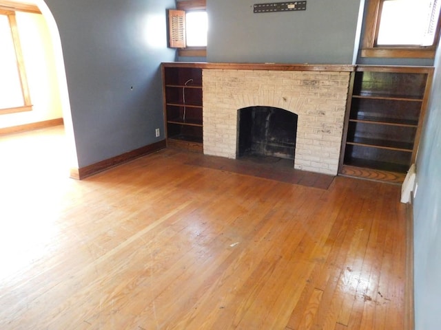 unfurnished living room with a fireplace and hardwood / wood-style flooring