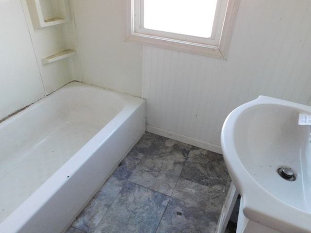 bathroom with a tub and sink