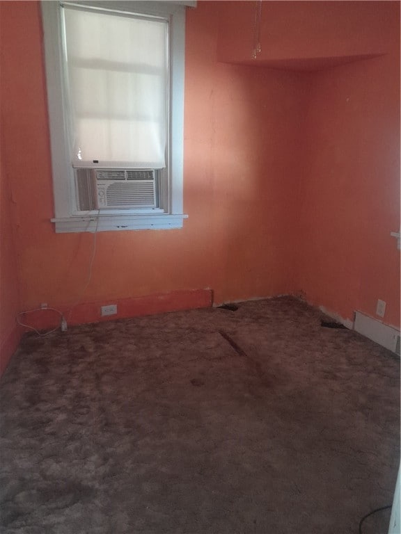 carpeted spare room featuring cooling unit