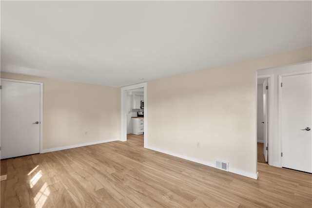 spare room with light hardwood / wood-style flooring