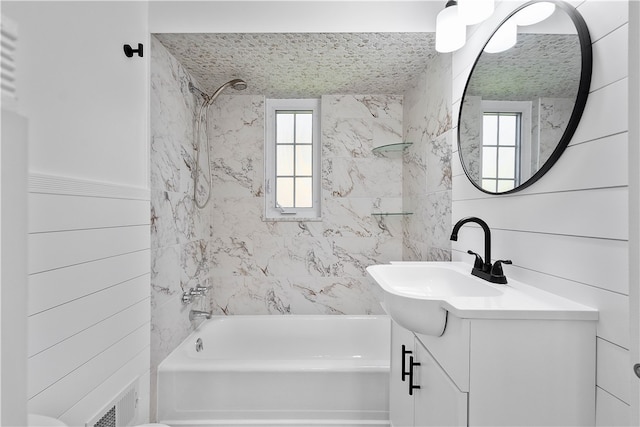 bathroom featuring vanity and tiled shower / bath combo