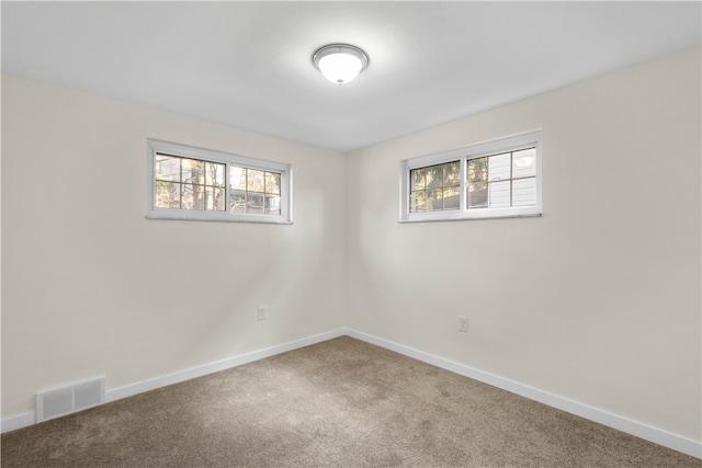 carpeted spare room with plenty of natural light