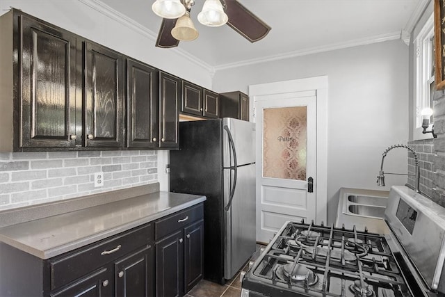 kitchen with tasteful backsplash, stainless steel appliances, ceiling fan, crown molding, and sink