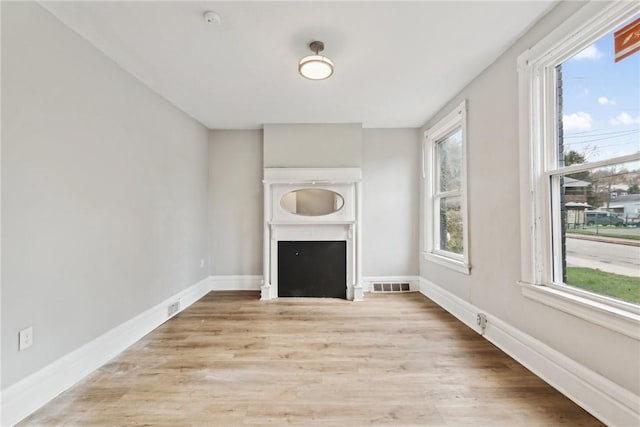 unfurnished living room with light hardwood / wood-style flooring