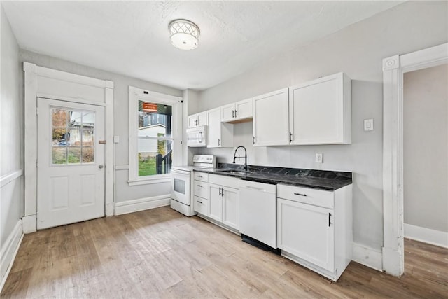 kitchen featuring white cabinetry, white appliances, sink, and light hardwood / wood-style flooring