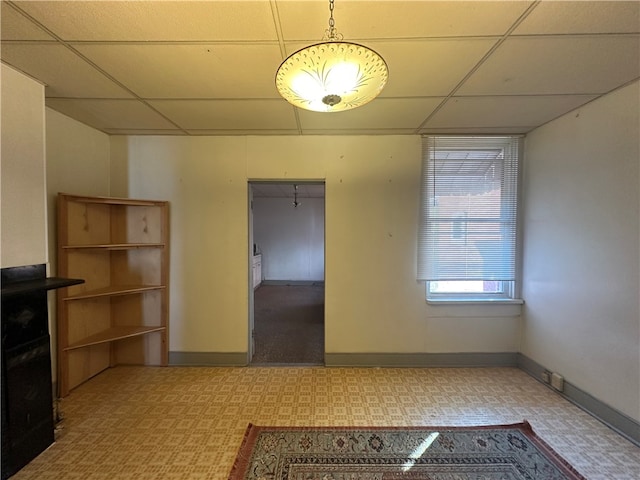 unfurnished dining area with a drop ceiling