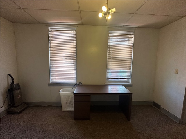 unfurnished office with a drop ceiling and dark colored carpet