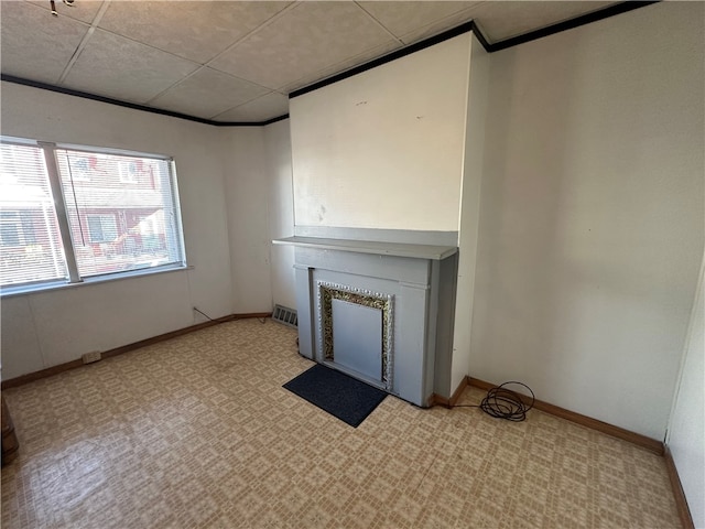 unfurnished living room featuring a paneled ceiling