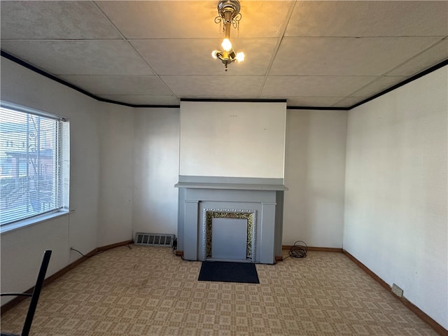 unfurnished living room featuring a drop ceiling