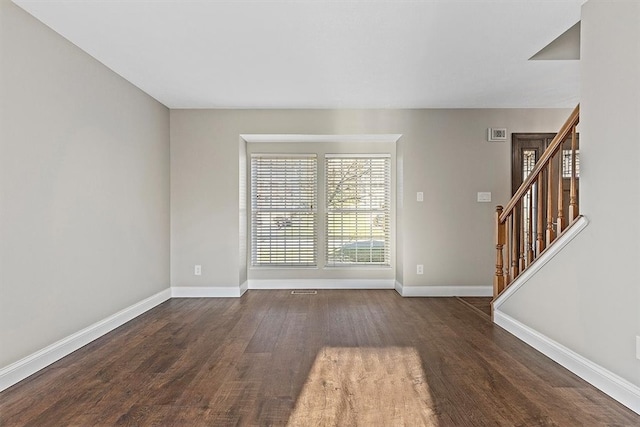 unfurnished room featuring dark hardwood / wood-style flooring