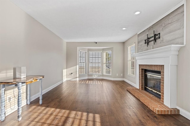 unfurnished living room with a fireplace and wood-type flooring