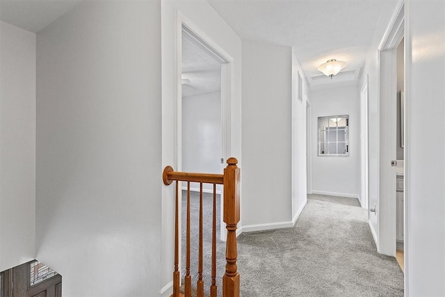 corridor featuring light colored carpet