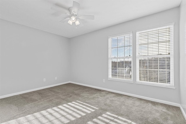 spare room featuring carpet floors and ceiling fan