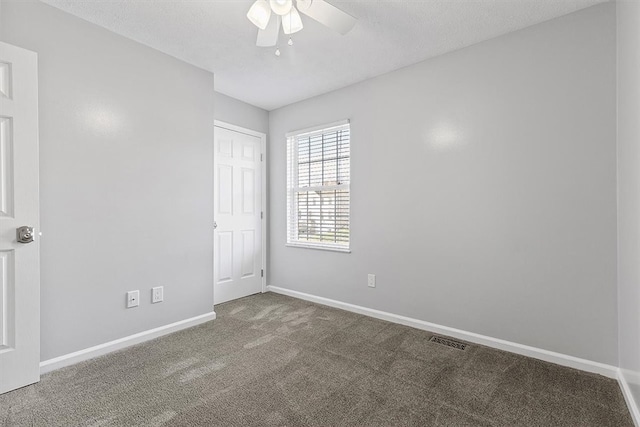 carpeted empty room with a textured ceiling and ceiling fan